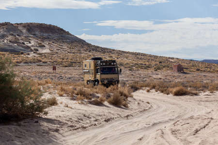 Lake Powell, Utah, USA - October 31, 2014:  An extreme off-road camping vehicle drives on a sand path near the shore of Lake Powell in Utah's Grand Staircase Escalante National Monument.のeditorial素材