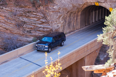 Zion National Park, Utah / USA - November 7, 2014:  A truck driving out of the tunnel and onto a bridge on a sunny fall day in Zion National Park, Utah.のeditorial素材