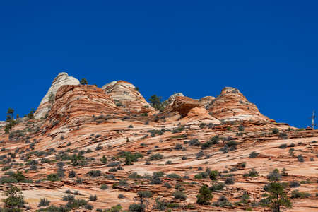 Swirling layers of sandstone that has eroded over time to form peaks or hoodoos in the landscape of Zion national Park located in Southern Utah.の写真素材