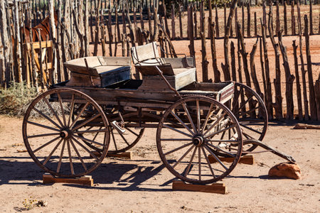 The frame and wheels of an old wagon displayed in the desert of the American southwest at Pipe Springs National Monument, Arizona.の写真素材