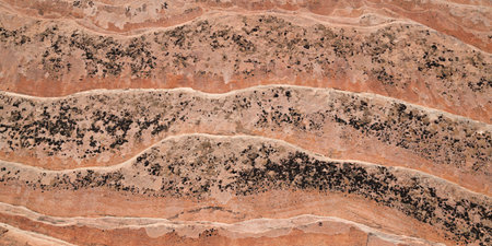 A section of ancient sandstone sediment showing eroded layers in a unique pattern as a background.