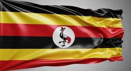 Uganda flag waving. Represents African nation, symbol of democracy,  country pride, patriotism. Background displays vibrant national banner emblem.の素材