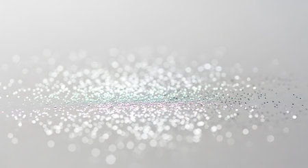 Scattered glitter on neutral backdrop. Shimmering dust abstract concept with light color effects. Elegant, celebration, surface, design, style, decoration.の素材