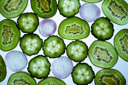 Still life with slices of cucumber, kiwi and onion