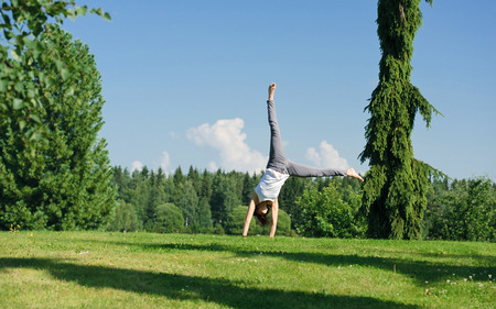 Young woman doing cartwheel outside