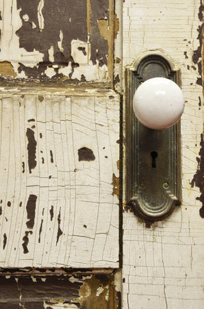 Old Vintage Door with Cracked Paint and White Door Knobの写真素材
