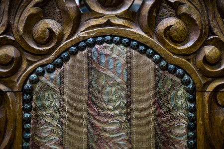 Old Fashioned Chair Close up with Wood Carving and Linear Fabricの写真素材