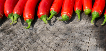 Colorful Red Serrano Peppers on a Wood Backgroundの写真素材