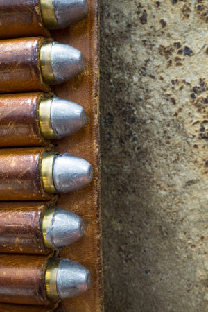 Detail of a Leather Gun Belt with Colt 45 Bulletsの写真素材