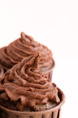 Chocolate cupcake on white background. Shallow dof.