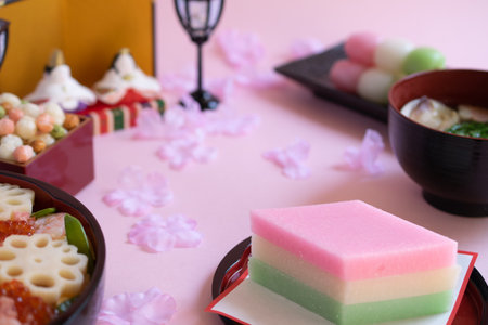 Close-up of diamond-shaped three-colored rice cakes (or so-called hishimochi) and other typical foods for celebrating Japanese Girls' Day.の写真素材