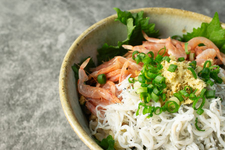 Two color topping (boiled baby sardine and sakura shrimp) rice bowl on table, closeupの写真素材