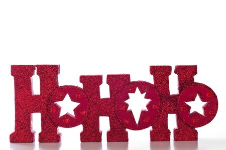 Word spells HoHoHo in red glittery letters; isolated on white background.の写真素材