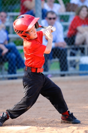 Little league baseball player full swing at batの写真素材