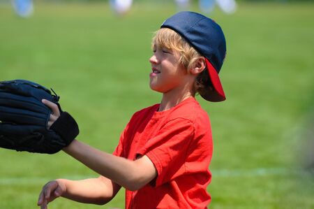 young boy wearing a baseball glove