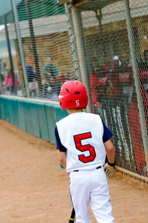 Little league baseball batter walking out to base.の写真素材