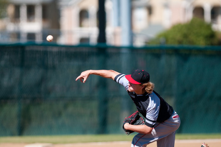 American teenage high school pitcher on the mound during a game.の写真素材