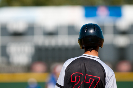 High school latino baseball player on base looking away from camera.の写真素材