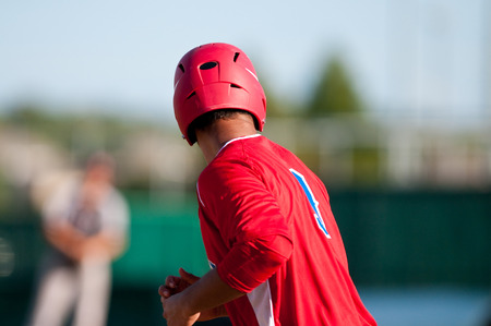 High school player during a game in red jersey.の写真素材
