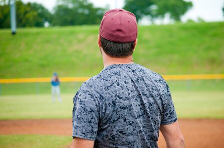 Baseball men in camo uniform looking away from camera.の写真素材
