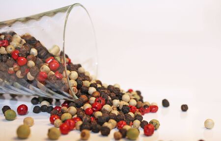Peppercorn Spices dumped from a glassの写真素材