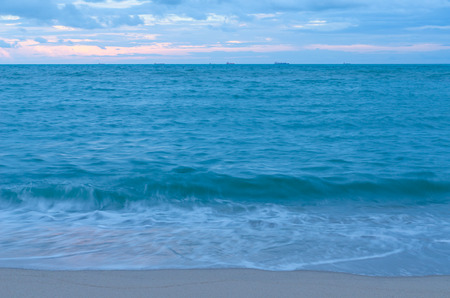 Oil tanker still anchor at the bay under blue clouds in the eveningの写真素材