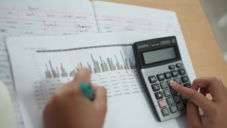 Businessman analyzing investment charts with calculator. Business and finance concept.の写真素材