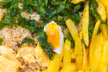 Closeup to Fried Rice with Crispy Basil, Fried Potatoes, and Salted Eggs Backgroundの写真素材