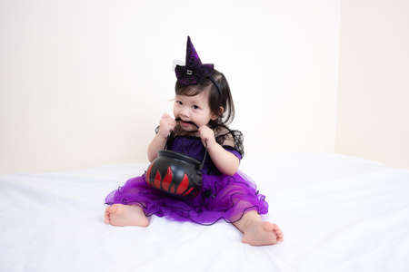 Asian Thai Cute Baby Girl in Witch Costume, Halloween Day
