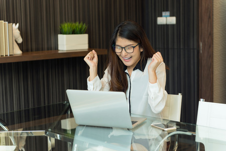 An asian business woman using a laptopの写真素材