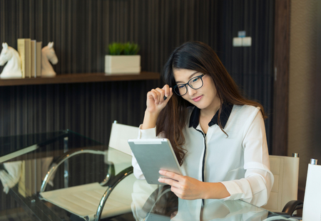 An asian business woman using a tablet	の写真素材