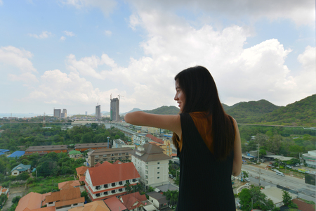 Asian girl in front of mountain in Sriracha, Chonburi, Thailandの写真素材