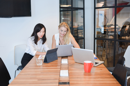 Group of business people meeting in a meeting room, sharing their ideasの写真素材