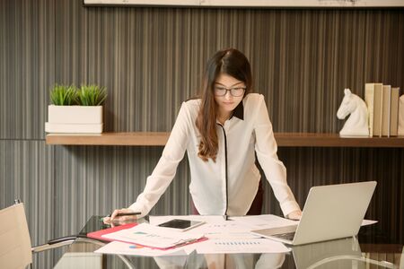 An Asian business woman presenting in meeting roomの写真素材