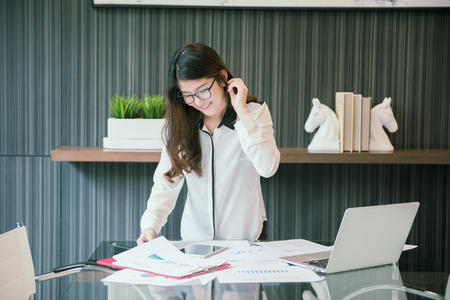 An Asian business woman presenting in meeting roomの写真素材
