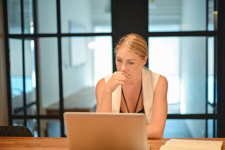 Depressed business blonde woman having troubles with her worksの写真素材