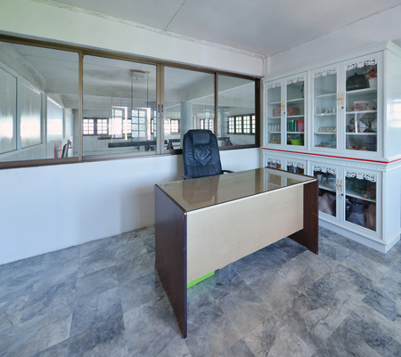Old modern working room with a desk and cabinetの写真素材