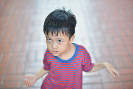 Portrait of cute Asian kid smiling isolatedの写真素材