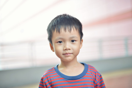 Portrait of cute Asian kid smiling isolatedの写真素材