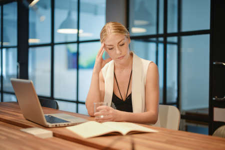 Depressed business blonde woman having troubles with her works