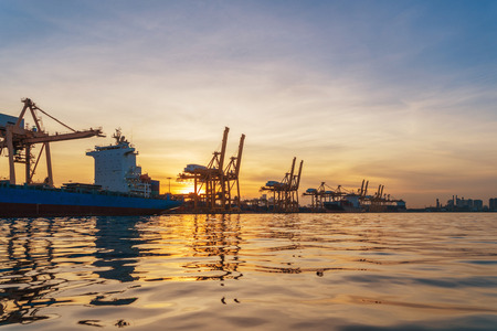 Container cargo ship in the export and import business and logistics international goods in urban...