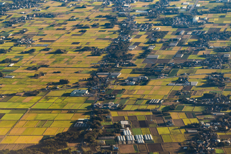 Aerial View of agricultural fields in countryside of Japan in spring season. Rural area. Rice farm...