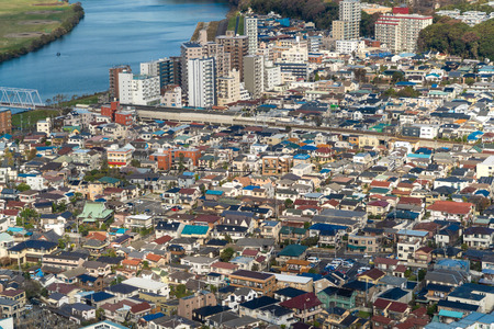Aerial view of Tokyo apartments in cityscape background. Residential district in smart city in Asia with river. Buildings at noon. Japanの写真素材