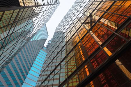 Golden building. Windows glass of modern office skyscrapers in technology and business concept. Facade design. Construction structure of architecture exterior for urban cityscape background.の写真素材