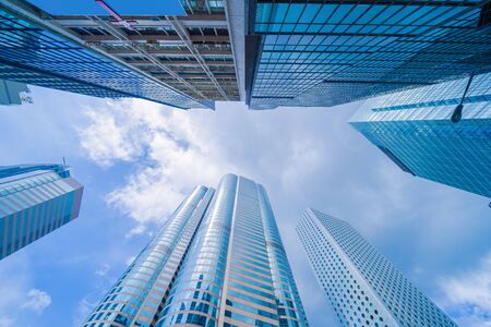 Looking up to high-rise office buildings, skyscrapers, architectures in financial district. Smart...