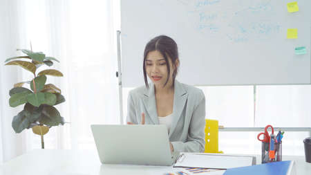 Portrait of a business Asian woman, Thai person talking to colleagues in webcam group video call...