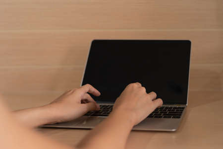 Business people working, typing on a keyboard with blank empty screen monitor on computer laptop...