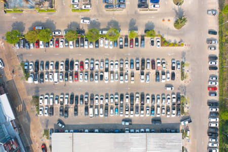 Aerial top view of cars in parking lots with street road in urban city. Transportation and vehiclesの写真素材