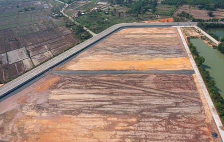 Aerial view of construction tractor car, bulldozer, or backhoe digging road or street in traffic...