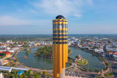 Aerial view of Roi Et tower, tourist attraction landmark. Urban housing development from above. Top...
